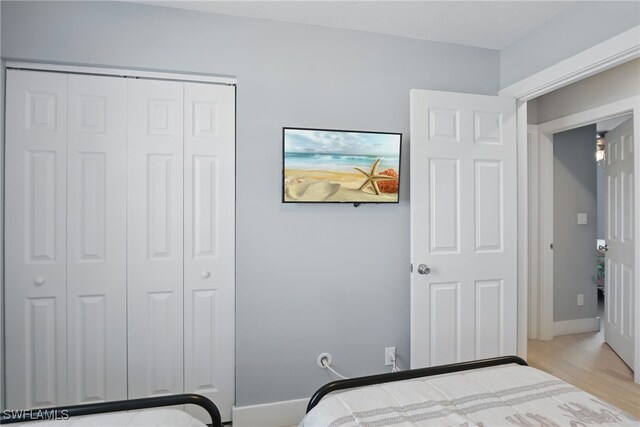 1357 Merrimac Ave, Marco Island, FL 34145 - bedroom with a closet, wood finished floors, and baseboards