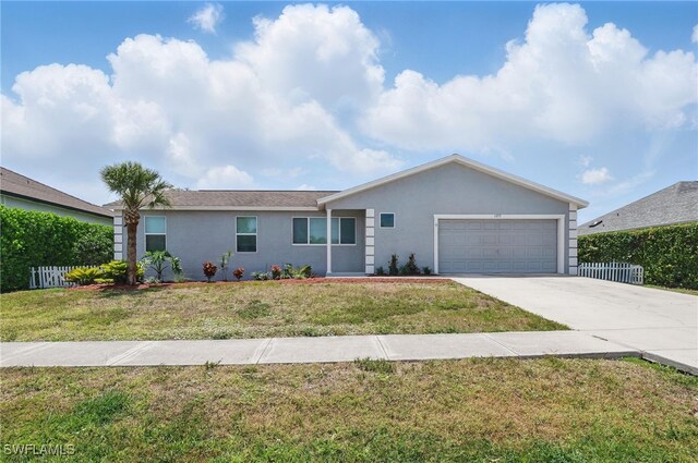 1357 Merrimac Ave, Marco Island, FL 34145 - single story home with an attached garage, stucco siding, fence, a front yard, and driveway