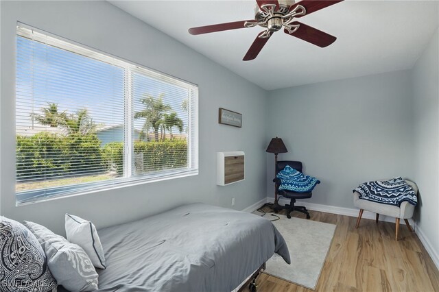 1357 Merrimac Ave, Marco Island, FL 34145 - bedroom with baseboards, light wood finished floors, and ceiling fan