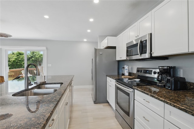 1357 Merrimac Ave, Marco Island, FL 34145 - kitchen featuring a sink, dark stone countertops, recessed lighting, white cabinetry, and appliances with stainless steel finishes