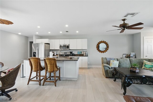 1357 Merrimac Ave, Marco Island, FL 34145 - kitchen with stainless steel appliances, white cabinets, a center island with sink, visible vents, and recessed lighting