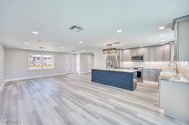 446 Lake Murex Cir, Sanibel, FL 33957 - kitchen with open floor plan, appliances with stainless steel finishes, gray cabinets, and visible vents