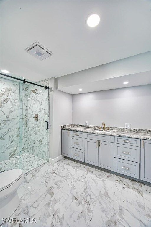 446 Lake Murex Cir, Sanibel, FL 33957 - bathroom featuring vanity, toilet, a marble finish shower, recessed lighting, and visible vents