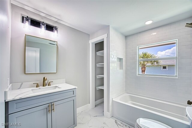 446 Lake Murex Cir, Sanibel, FL 33957 - bathroom with vanity, baseboards, toilet, marble finish floor, and washtub / shower combination