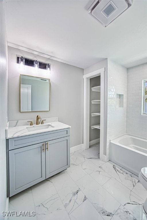 446 Lake Murex Cir, Sanibel, FL 33957 - bathroom with vanity, marble finish floor, toilet, a washtub, and baseboards