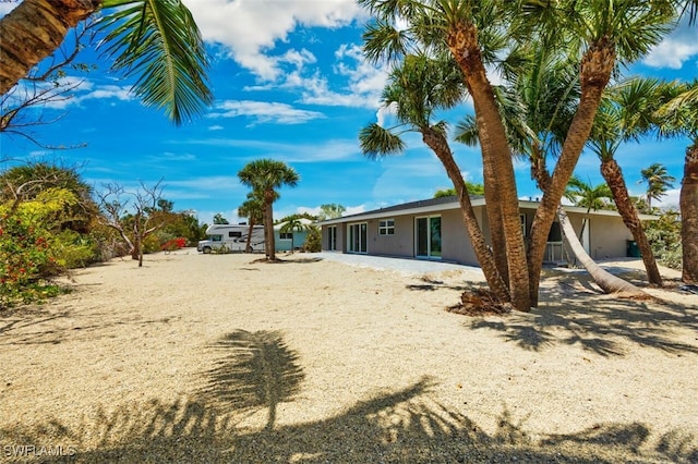446 Lake Murex Cir, Sanibel, FL 33957 - rear view of property featuring stucco siding