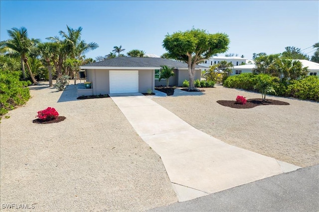 446 Lake Murex Cir, Sanibel, FL 33957 - ranch-style house with an attached garage, stucco siding, and driveway