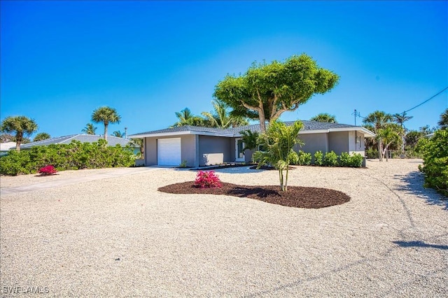 446 Lake Murex Cir, Sanibel, FL 33957 - single story home featuring concrete driveway, an attached garage, and stucco siding