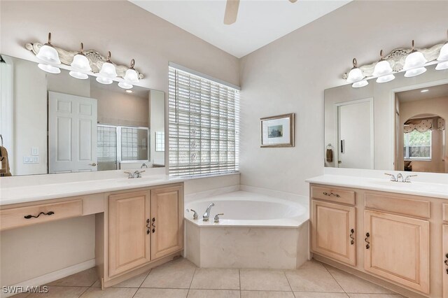 317 Harvard Ln, Naples, FL 34104 - bathroom with a stall shower, a bath, two vanities, and tile patterned floors