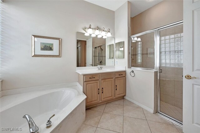 317 Harvard Ln, Naples, FL 34104 - bathroom featuring a bath, vanity, a stall shower, and tile patterned floors