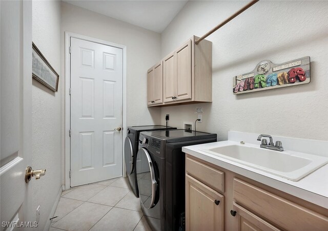 317 Harvard Ln, Naples, FL 34104 - laundry room featuring washer and clothes dryer, cabinet space, light tile patterned flooring, and baseboards