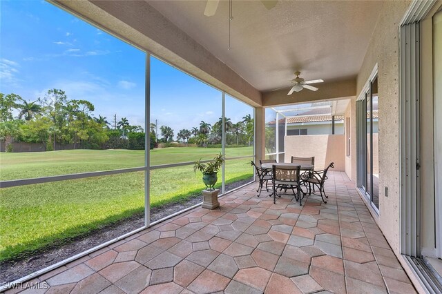 317 Harvard Ln, Naples, FL 34104 - sunroom / solarium with ceiling fan, view of golf course, and outdoor dining area