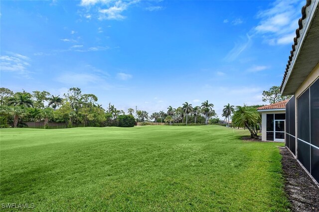 317 Harvard Ln, Naples, FL 34104 - view of green lawn with golf course view and a sunroom