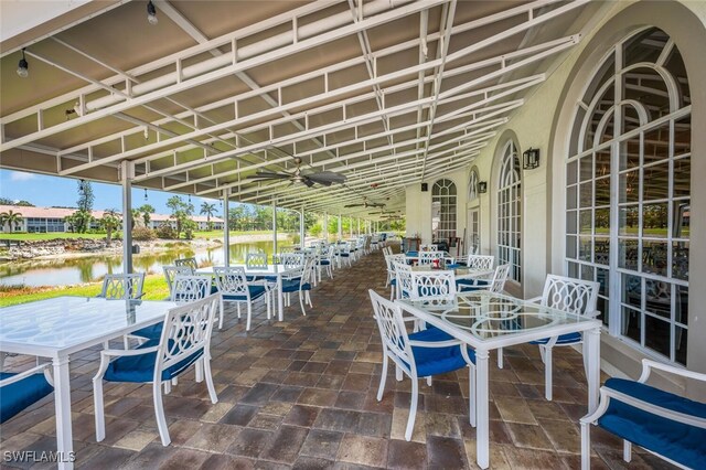 317 Harvard Ln, Naples, FL 34104 - view of patio featuring outdoor dining area and a water view