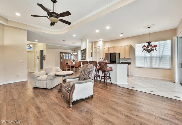 317 Harvard Ln, Naples, FL 34104 - living room featuring a chandelier, crown molding, light wood-style floors, baseboards, and recessed lighting
