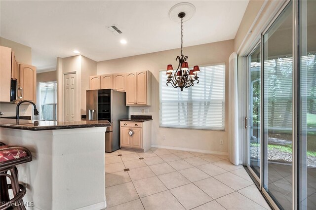 317 Harvard Ln, Naples, FL 34104 - kitchen featuring stainless steel appliances, healthy amount of natural light, and light brown cabinets