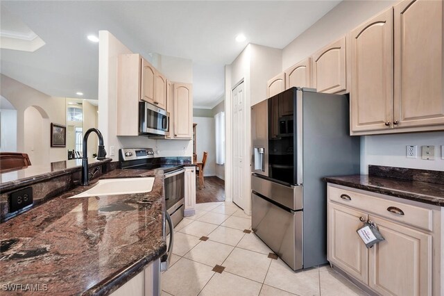 317 Harvard Ln, Naples, FL 34104 - kitchen featuring appliances with stainless steel finishes, a sink, crown molding, arched walkways, and light brown cabinets