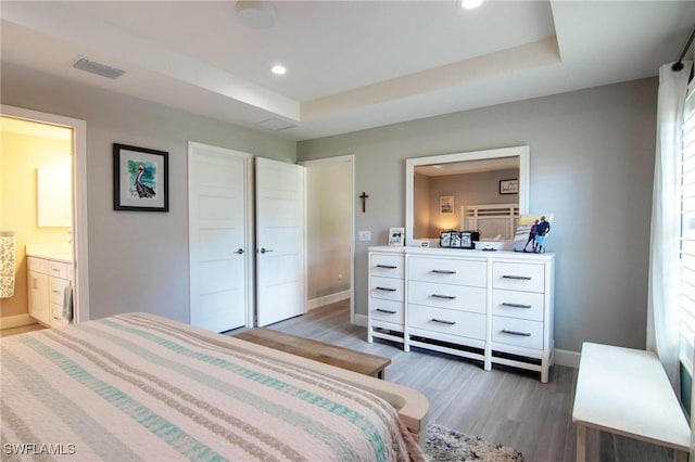 9179 Prospect Ave, Englewood, FL 34224 - bedroom with baseboards, recessed lighting, ensuite bathroom, visible vents, and wood finished floors