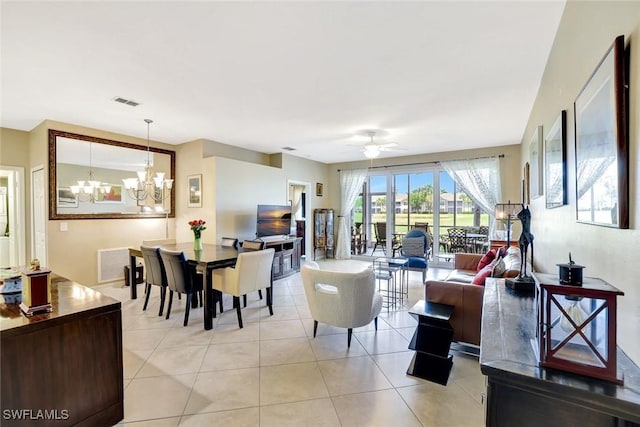dining room with ceiling fan with notable chandelier, visible vents, and light tile patterned flooring
