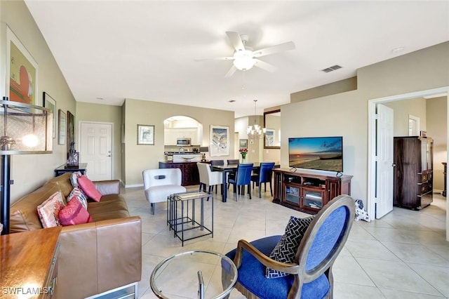 living room with baseboards, visible vents, light tile patterned floors, and ceiling fan with notable chandelier