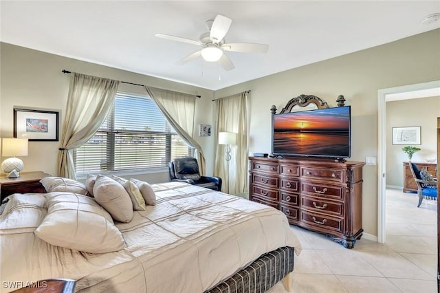 bedroom featuring a ceiling fan, baseboards, and light tile patterned floors