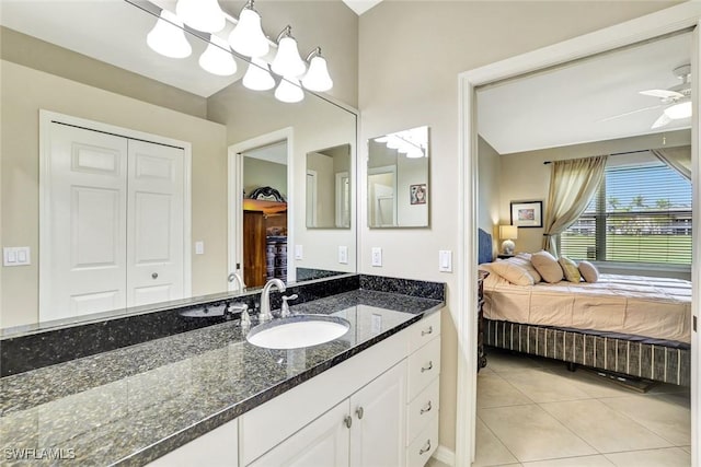 bathroom with a ceiling fan, ensuite bath, tile patterned flooring, and vanity
