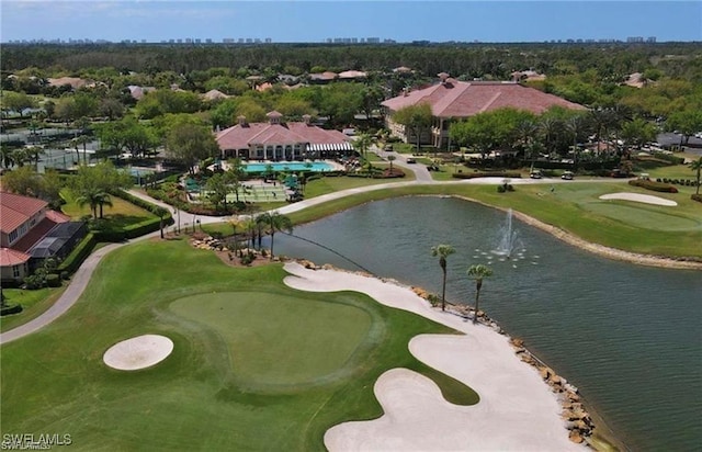 drone / aerial view featuring view of golf course, a water view, and a residential view