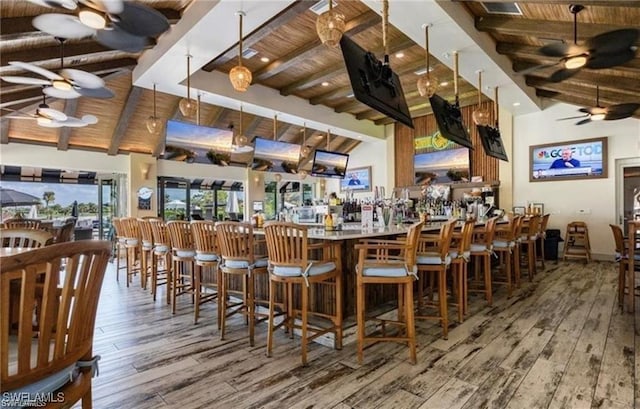 bar featuring wood ceiling, a ceiling fan, beam ceiling, and hardwood / wood-style floors