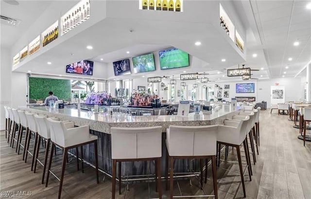bar with recessed lighting, visible vents, and light wood finished floors