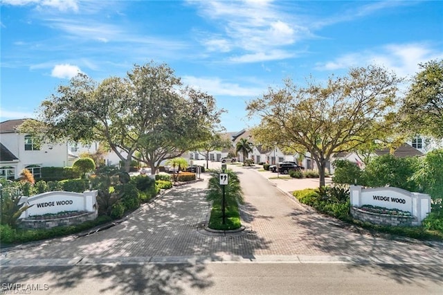 view of road with a residential view and curbs