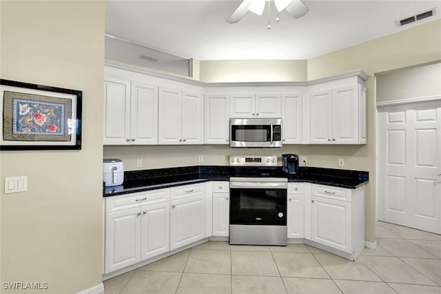 kitchen featuring white cabinets, stainless steel appliances, light tile patterned flooring, visible vents, and ceiling fan