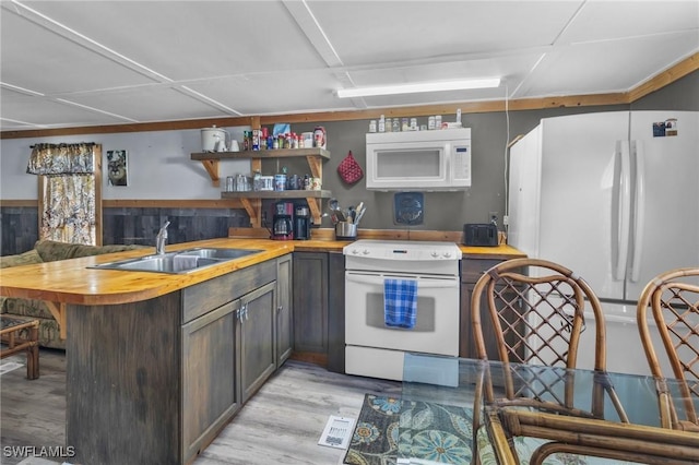 268 Mamie St, Chokoloskee, FL 34138 - kitchen featuring open shelves, a sink, white appliances, light wood-style floors, and butcher block countertops