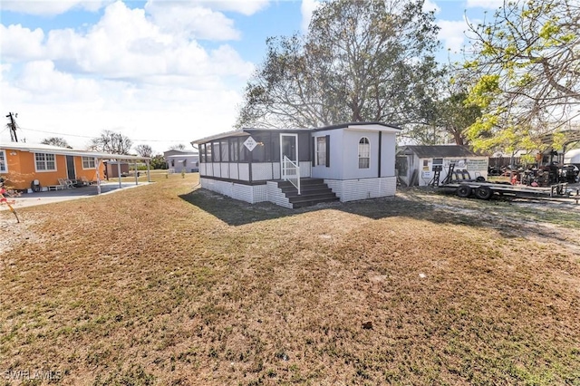 268 Mamie St, Chokoloskee, FL 34138 - exterior space with a sunroom and a yard