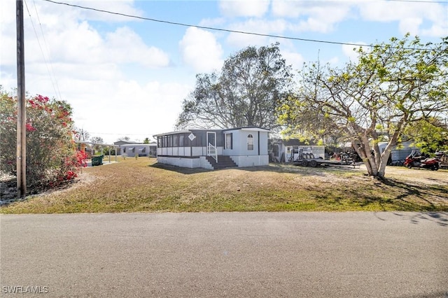 268 Mamie St, Chokoloskee, FL 34138 - manufactured / mobile home with a sunroom and a front yard