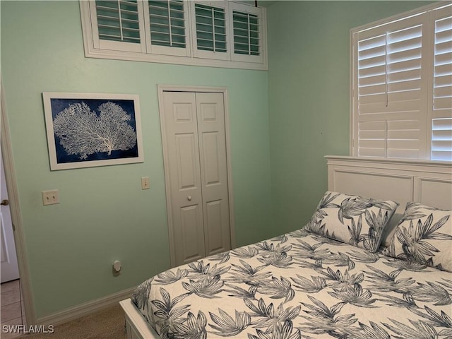 3323 SW 25th Ct, Cape Coral, FL 33914 - carpeted bedroom featuring baseboards and a closet