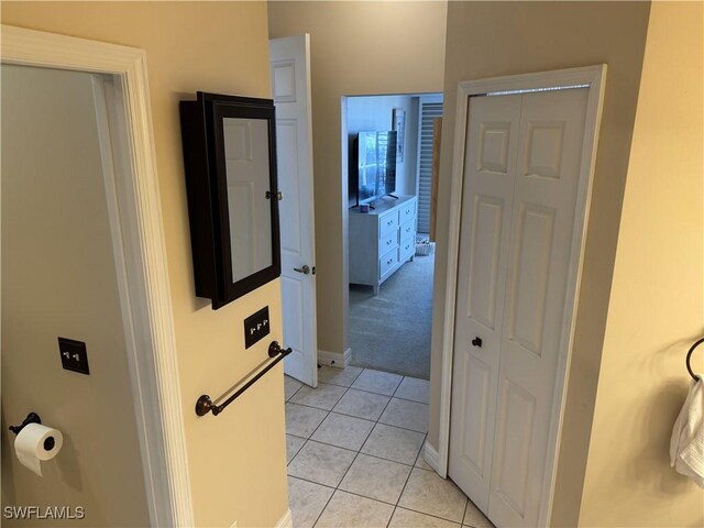3323 SW 25th Ct, Cape Coral, FL 33914 - hall with baseboards, light tile patterned floors, and light colored carpet