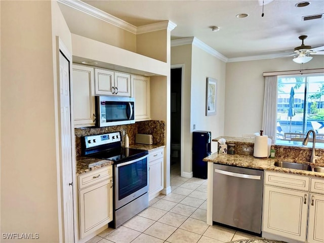 3323 SW 25th Ct, Cape Coral, FL 33914 - kitchen with backsplash, visible vents, a sink, crown molding, and appliances with stainless steel finishes