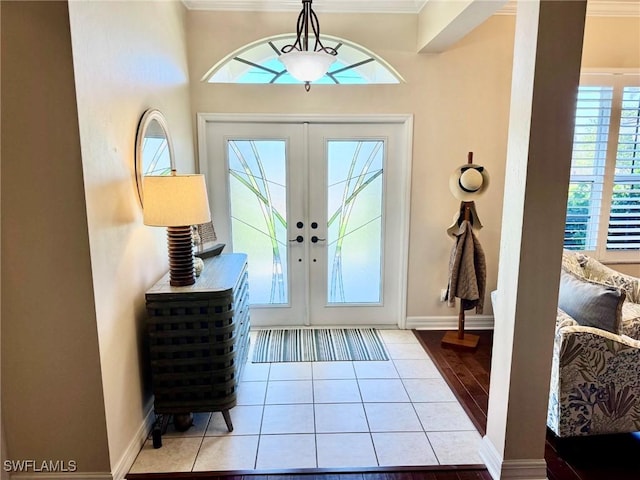 3323 SW 25th Ct, Cape Coral, FL 33914 - tiled foyer featuring crown molding, baseboards, and french doors