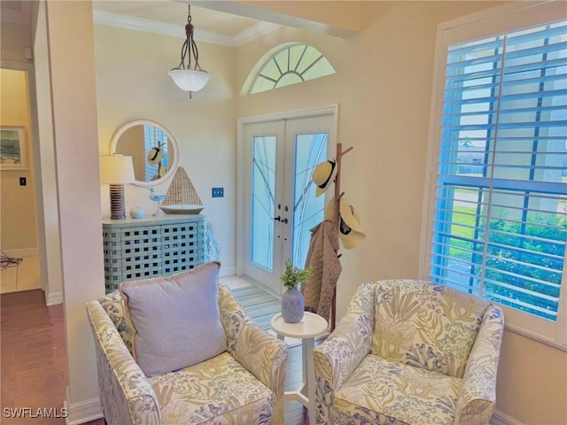 3323 SW 25th Ct, Cape Coral, FL 33914 - living area featuring wood finished floors, crown molding, baseboards, and french doors