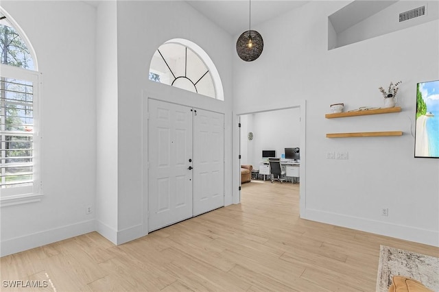595 31st St NW, Naples, FL 34120 - entrance foyer with high vaulted ceiling, light wood-style flooring, and baseboards