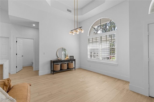 595 31st St NW, Naples, FL 34120 - dining area with light wood-style flooring, baseboards, and a towering ceiling
