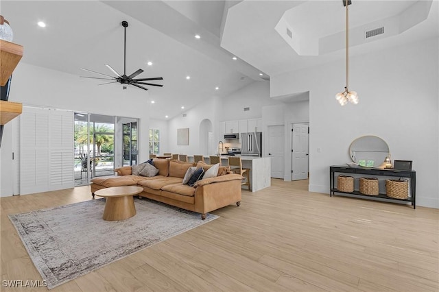 595 31st St NW, Naples, FL 34120 - living room featuring high vaulted ceiling, ceiling fan, arched walkways, recessed lighting, and light wood finished floors