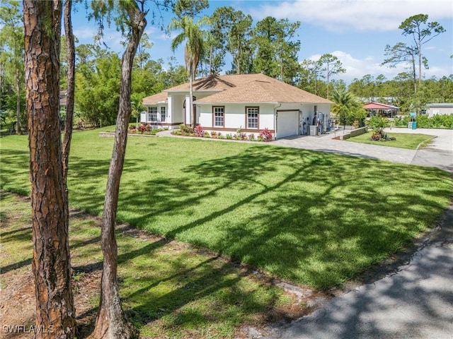 595 31st St NW, Naples, FL 34120 - single story home featuring a garage, driveway, a front yard, and stucco siding