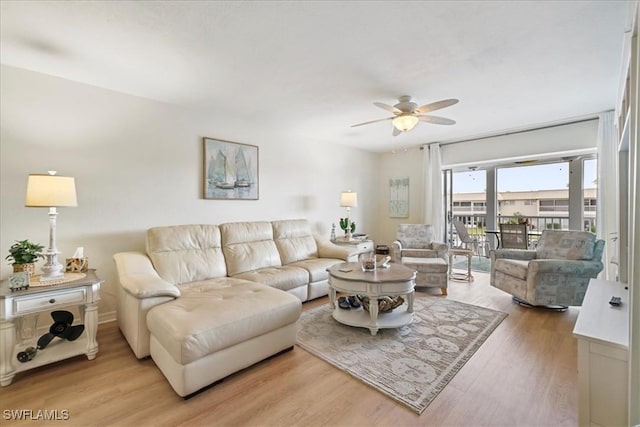 living room featuring a ceiling fan and light wood finished floors