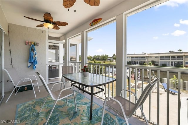 sunroom / solarium featuring ceiling fan
