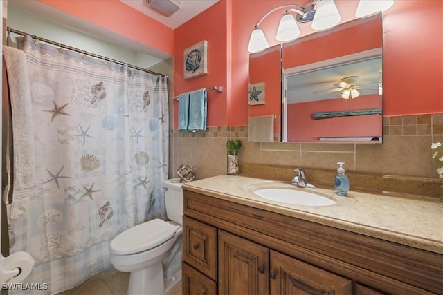 bathroom with vanity, a ceiling fan, toilet, tile walls, and tile patterned floors