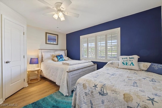 bedroom with a ceiling fan and wood finished floors