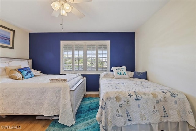 bedroom featuring a ceiling fan and wood finished floors