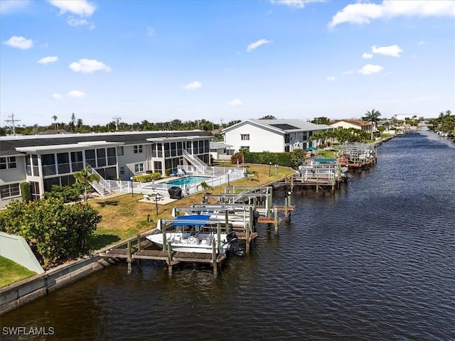 view of dock with a water view, fence, and boat lift