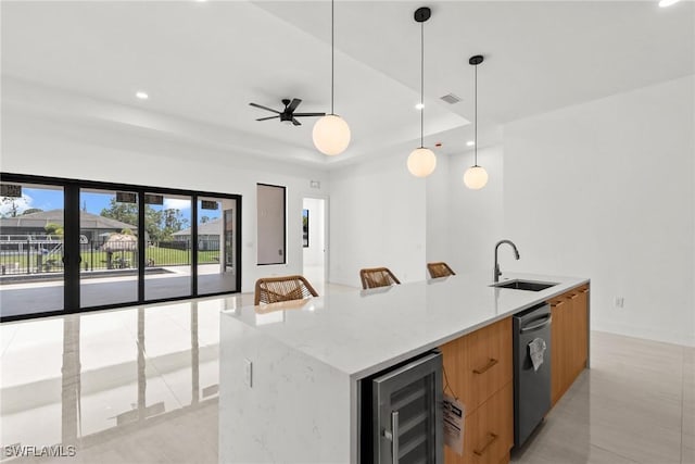 kitchen featuring modern cabinets, a sink, beverage cooler, recessed lighting, and open floor plan